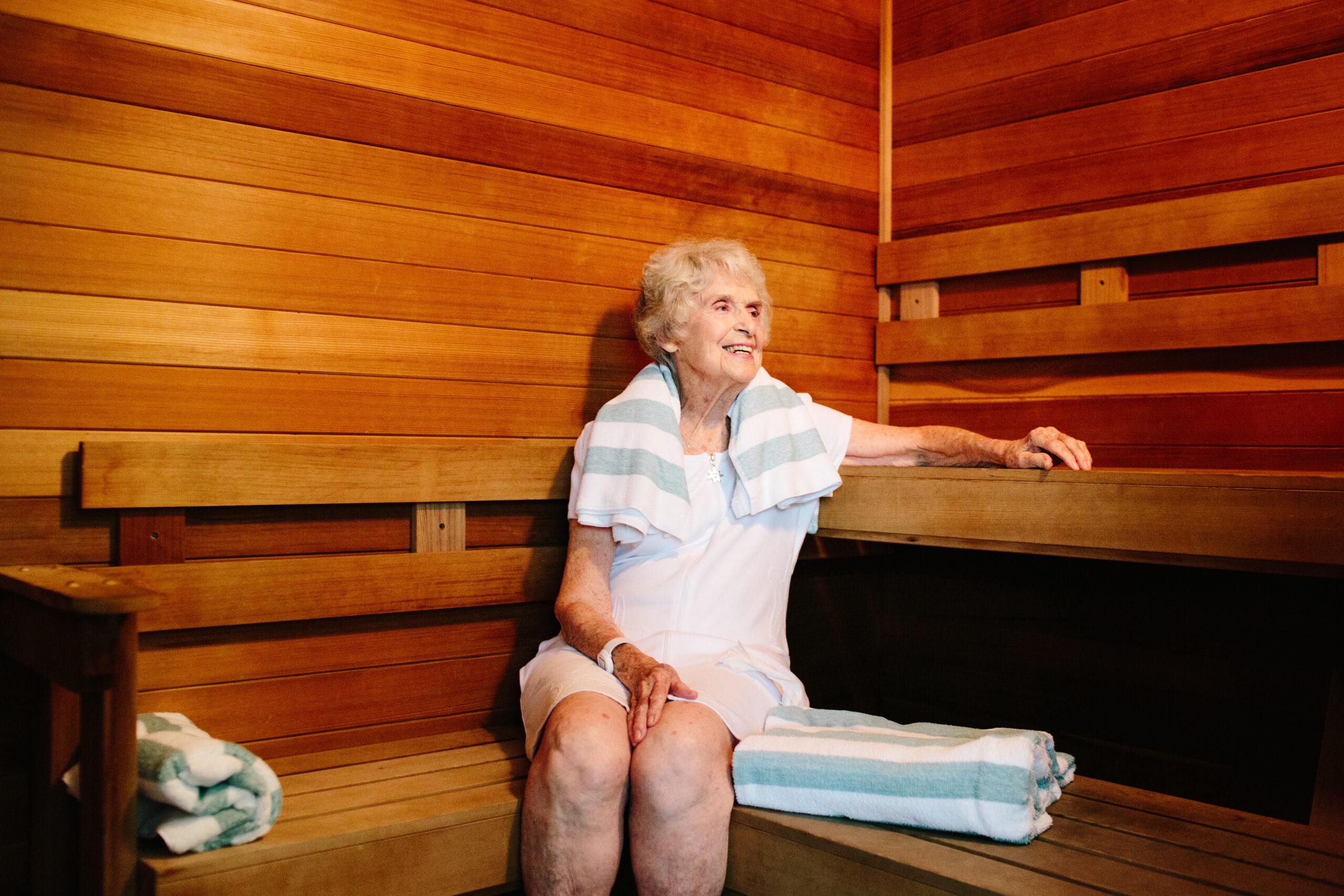 An older woman relaxes in the sauna